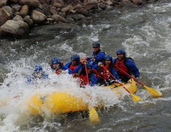 A group of whitewater rafters on a Colorado river